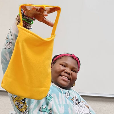 West Campus Student Showing Off Her Sewing Project