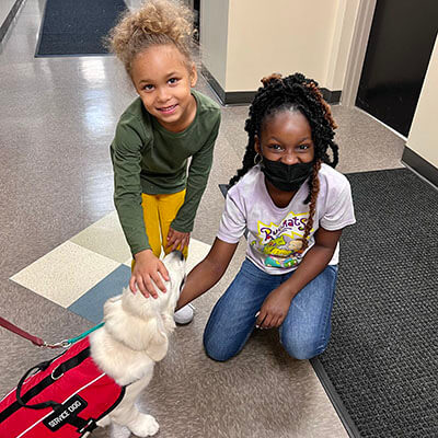 Broach School South Students petting a Service Dog in Training